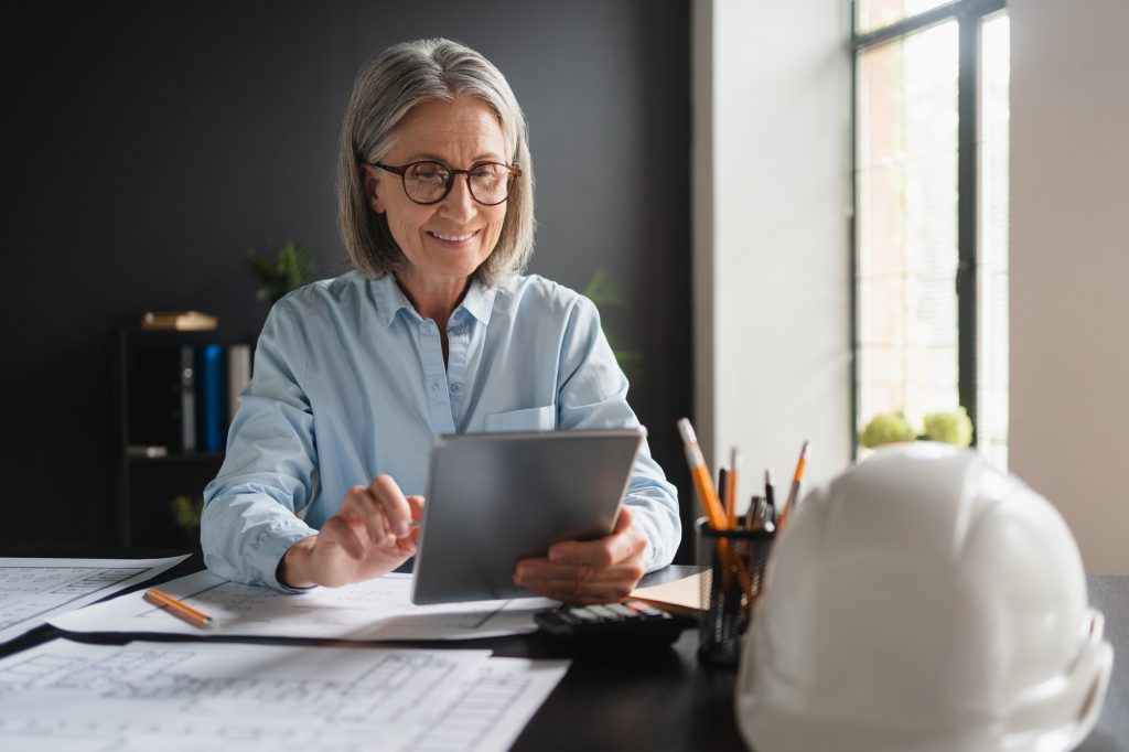 Female architect working on tablet in the office.